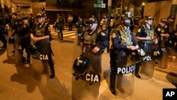 Police guard outside President Dina Boluarte's house during a raid ordered by the Attorney General's Office aimed at seizing Rolex watches as part of a preliminary investigation into alleged illicit enrichment in Lima, Peru, March 30, 2024.