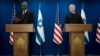 Israel Minister of Defense Yoav Gallant, right, listens to his U.S. counterpart, Secretary of Defense Lloyd Austin, making a joint statement after their meeting about Israel's military operation in Gaza, in Tel Aviv, Dec. 18, 2023. 
