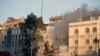 Emergency services work at a destroyed building hit by an airstrike in Damascus, Syria, April 1, 2024. 