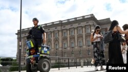 A police officer on a Segway patrols Sweden's parliament building in Stockholm, Aug. 17, 2023. (Fredrik Sandberg/TT News Agency/via Reuters)