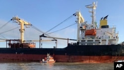 In this photo provided by Ukraine's Border Guard Service, a Panama-flagged civilian cargo vessel is seen in Odesa region, Dec. 28, 2023. The vessel hit a Russian mine resulting in two injured sailors, said Ukraine's Southern Defense Forces.