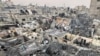 People search through the rubble of damaged buildings following an Israeli air strike on Palestinian houses, in Rafah, southern Gaza Strip, Dec. 12, 2023. 