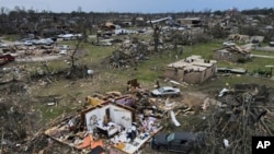 Toneladas de escombros esparcidos sobre las casas dañadas por el tornado, el domingo 26 de marzo de 2023, en Rolling Fork, Mississippi. Al menos 25 personas murieron y docenas resultaron heridas cuando la tormenta masiva azotó varias ciudades de la región. (Foto AP/Julio Cortés)