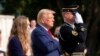 Misty Fuoco, left, sister of Nicole Gee, and Republican presidential nominee former President Donald Trump place their hands over their heart after placing a wreath in honor of Sgt. Nicole Gee at Arlington National Cemetery, Aug. 26, 2024. 