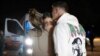 Maya Shem, center, is greeted by her mother and brother as she arrives at the Hatzerim Air Base, Nov. 30, 2023, in Israel after being released from Hamas captivity. (GPO/Handout via AP)
