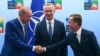 FILE - Turkey's President Recep Tayyip Erdogan, left, shakes hands with Swedish Prime Minister Ulf Kristersson, right, as NATO Secretary General Jens Stoltenberg looks on prior to a meeting ahead of a NATO summit in Vilnius, Lithuania, July 10, 2023.