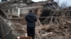 A resident looks at the remains of an industrial building after a Russian rocket attack in Sloviansk, Ukraine, Jan. 27, 2024. 