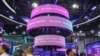 FILE - Visitors walk past an Amazon exhibition booth during the World Artificial Intelligence Conference in Shanghai on July 5, 2024.