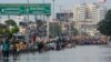People wade through a flooded street following heavy rains along the Bay of Bengal coast in Chennai, India, Dec.5, 2023, as cyclone Michaung made landfall along the country's southeastern coastline.