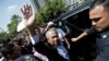 FILE - Former Malaysian Prime Minister Muhyiddin Yassin waves outside Kuala Lumpur Court Complex in Kuala Lumpur, March 10, 2023. 