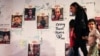People walk in front of images of Israeli hostages held in Gaza since the Oct. 7 attack by Hamas militants in southern Israel during a protest to ask for their release in Tel Aviv, Nov. 22, 2023.