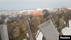 Riot police disperse a rally in support of Fail Alsynov, who was charged with inciting ethnic hatred and sentenced to four years in a prison colony, in Baymak in the republic of Bashkortostan, Russia, in this still from a Jan. 17, 2024, video.