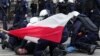 Police officers restrain a demonstrator during a farmers' protest against the European Union's Green Deal and imports of Ukrainian agricultural products, in Warsaw, Poland, March 6, 2024. 