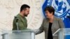 Ukrainian President Volodymyr Zelenskyy shakes hands with International Monetary Fund Director Kristalina Georgieva following talks at IMF headquarters in Washington, Dec. 11, 2023.