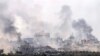 A picture taken from southern Israel near the border with the Gaza Strip on Dec. 10, 2023, shows smoke rising above buildings during Israeli bombardments on Khan Yunis. 