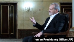 In this photo released by the Iranian Presidency Office, President Masoud Pezeshkian speaks in a live televised interview by state TV, at his office in Tehran, Iran, Aug. 31, 2024. (Iranian Presidency Office via AP)