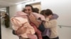 Aviv Asher, 2.5; her sister Raz Asher, 4.5, and mother Doron meet with Yoni, Doron's husband and their father, after they returned to Israel to the designated complex at the Schneider Children's Medical Center on Nov. 24, 2023. 