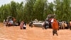 This photograph taken Aug. 20, 2024 shows police boats being used to carry people following heavy rains that damaged National Road 25 from the Nigerien capital Niamey to the provinces of Tillabéri and Tahoua in western Niger. 