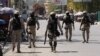 FILE - Police patrol a street after authorities extended the state of emergency amid gang violence that has threatened to bring down the government, forcing thousands to flee their homes, in Port-au-Prince, Haiti, March 8, 2024. 
