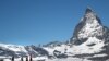 FILE - Tourists take a picture in front of the Matterhorn mountain at the Gornergrat in Zermatt, Switzerland June 2, 2019.