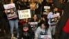 Relatives and supporters hold placards bearing portraits of Israeli hostages during a rally in Tel Aviv, Israel, calling for their release, Jan. 20, 2023. 