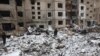 Police and residents inspect damage outside a destroyed building after a Russian missile attack in Kyiv, Jan. 3, 2024. Meanwhile, Ukraine said on Thursday that its air force struck two Russian military targets in occupied Crimea, including a command post near Sevastopol.