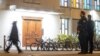 Police officers stand guard at the Agudas Achim Synagogue in Zurich, Switzerland, March 3, 2024, after an Orthodox Jewish man was stabbed in the city's center late on March 2, 2024.
