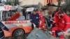 Palestinian Red Crescent personnel check a destroyed ambulance in Deir el-Balah in the central Gaza Strip, on Jan. 11, 2024.