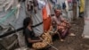 People sit at the Don Bosco refugee camp as Red Cross officials create awareness around mpox in Goma, Democratic Republic of Congo, Aug. 22, 2023. 