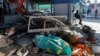 Debris and what appears to be a covered body are seen at a market in Russia-occupied Donetsk, Ukraine, Jan. 21, 2024, after what local Russian authorities said was a Ukrainian military strike.
