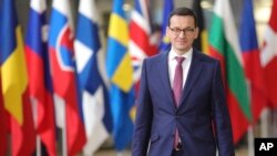 FILE - A Dec. 14, 2017 file photo shows Polish Prime Minister, Mateusz Morawiecki, arriving for an EU summit at the Europa building in Brussels. Poland's new prime minister is looking to improve strained relations with partners in the European Union when he arrives in Brussels on Jan. 9. 2017.