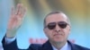 Turkey's President Recep Tayyip Erdogan waves to supporters as he attends an opening ceremony for a rail commute line in Ankara, Turkey, April 12, 2018.