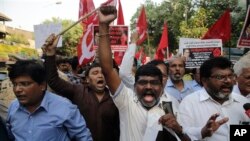 Members of Dalit organizations and leftist groups shout slogans as they hold placard during a protest in Mumbai, India, April 2, 2018.