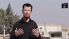 FILE - In this still image taken from an undated video published on the Internet by the Islamic State group militants, captive British journalist John Cantlie speaks into a camera in what he identifies as the embattled Syrian town of Kobani. 