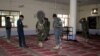 Afghan policemen inspect a mosque after a blast in Khost province, Afghanistan, May 6, 2018. 