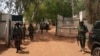 FILE - Nigerian soldiers and police officers stand at the entrance of a school in Kaduna state, on March 12, 2021, after a mass abduction. Family members report that on March 7, 2024, dozens of students were kidnapped from a school in the town of Kuriga. 