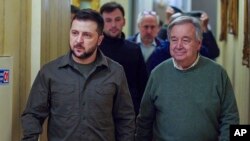 FILE - In this image provided by the Ukrainian Presidential Press Office, Ukrainian President Volodymyr Zelenskyy, left, and U.N. Secretary-General Antonio Guterres walk in a hallway during their meeting in Kyiv, Ukraine, April 28, 2022.