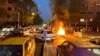 FILE - A police motorcycle burns during a protest over the death of Mahsa Amini, a woman who died after being arrested by the Islamic republic's "morality police", in Tehran, Iran, Sept. 19, 2022.
