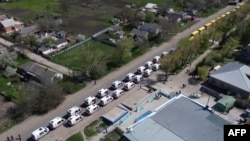 FILE - This video grab taken from a handout footage released by the Russian Defense Ministry on May 2, 2022 shows civilians being evacuated from an area near the Azovstal steel plant in Mariupol.