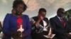 Twenty years after the 1998 U.S. embassy bomb attack in Nairobi, Kenya, emotion overwhelms a survivor (center) at a memorial park. Hundreds gathered there Aug. 7, 2018, to remember. (M. Yusuf/VOA)