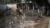 Afghan Security personnel inspect the site of a suicide attack in the Kama district of Nangarhar province, east of Kabul, Afghanistan, Oct. 2, 2018. 