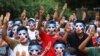 FILE - Young demonstrators flash the three-fingered symbol of resistance during an anti-coup mask strike in Yangon, Myanmar, April 4, 2021.