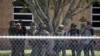 ARCHIVO - Agentes del orden están parados afuera de la Escuela Primaria Robb tras un tiroteo fatal el 24 de mayo del 2022 en Uvalde, Texas.