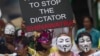 Masked Thai protesters holding placards and banners stage an anti-government rally in Bangkok, May 31, 2013. 