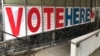 A 'Vote Here' sign marks the entrance on Sept. 20, 2018, to an early voting station in downtown Minneapolis.