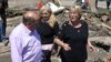 Chile's President Michelle Bachelet (2ndR) talks to residents in a destroyed area of Concepcion, some 100 km (62 miles) south of the epicenter of a huge 8.8-magnitude earthquake that rocked Chile on February 27, 2010