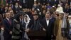 Afghanistan's President Ashraf Ghani, center, speaks to journalists after arriving to register as a candidate for the presidential election at the Independent Elections Commission, in Kabul, Jan. 20, 2019. 
