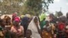 FILE - Displaced women gather at the Centro Agr‡rio de Napala, where hundreds of displaced who arrived in recent months are sheltered, fleeing attacks by armed insurgents in different areas of the province of Cabo Delgado, Mozambique, Dec. 11, 2020.