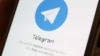 The Telegram logo is seen on a screen of a smartphone in this illustration, April 13, 2018.