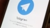 The Telegram logo is seen on a screen of a smartphone in this illustration, April 13, 2018.